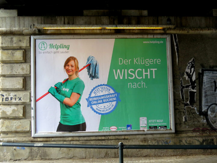 Werbeplakat mit Frau und Wischmopp, Text: "Reinigungskraft online buchen".
