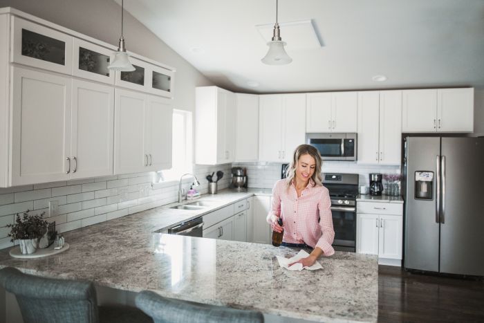 Woman Cleaning Kitchen Counter Home