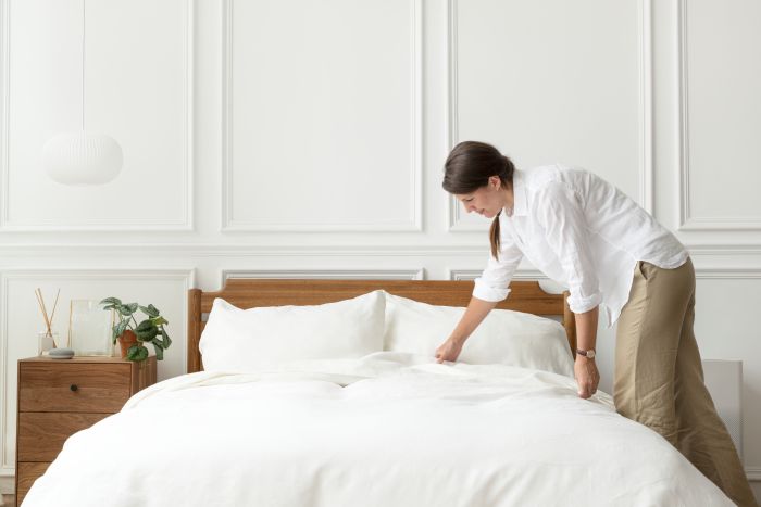 Woman Making Her Bed Scandinavian Interior Style