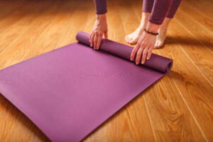 Woman Lays Out Lilac Yoga Mat Wooden Floor Women Practicing Yoga Healthy Lifestyle Isolation 1 300X200 1