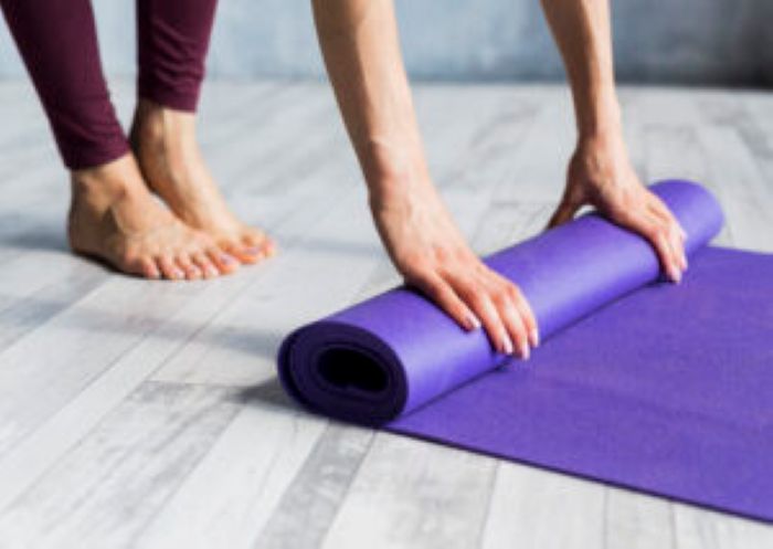 Woman Rolling Her Yoga Mat 300X213 1