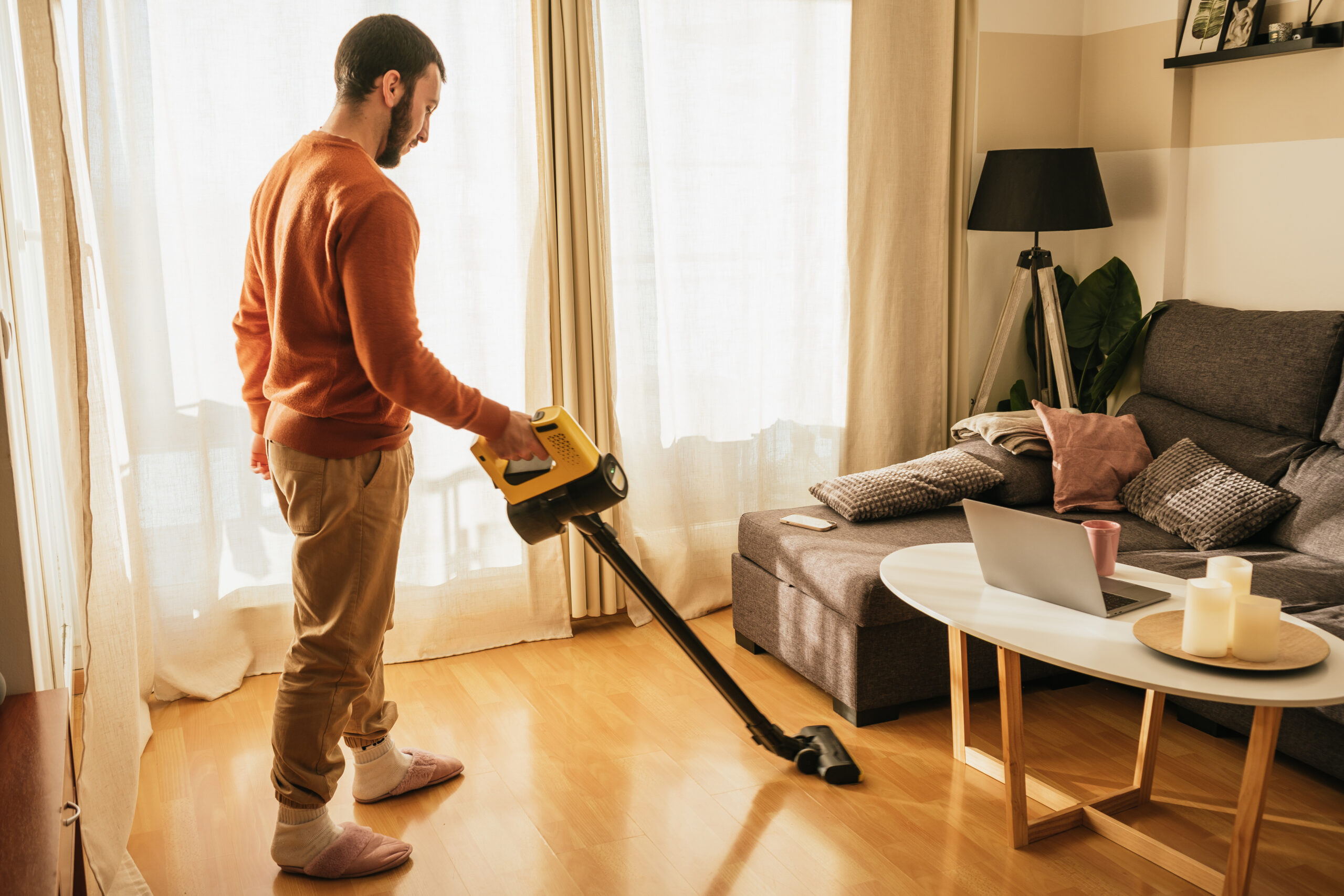 Man Vacuuming His Apartment Scaled