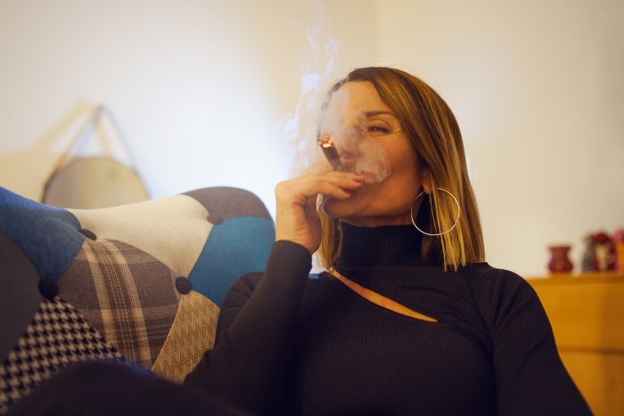 Woman Smoking Cigar While Relaxing Home