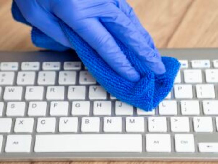 Hand With Surgical Glove Cleaning Keyboard With Cloth 300X225 1