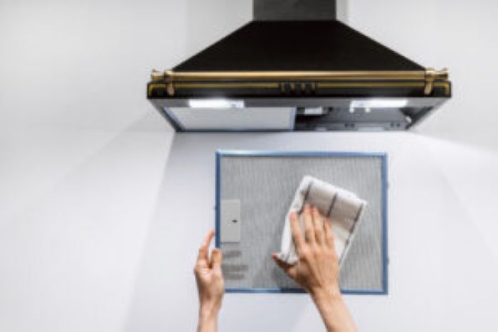 Woman Washing Cooker Hood Filter Kitchen 300X200 1