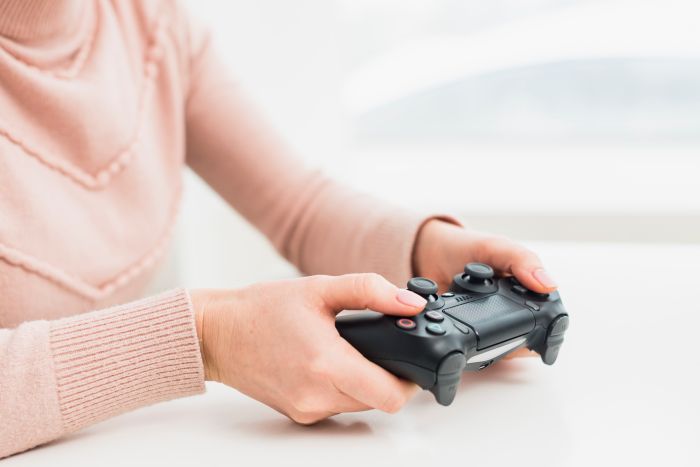 Woman Pink Clothes Playing Game Console