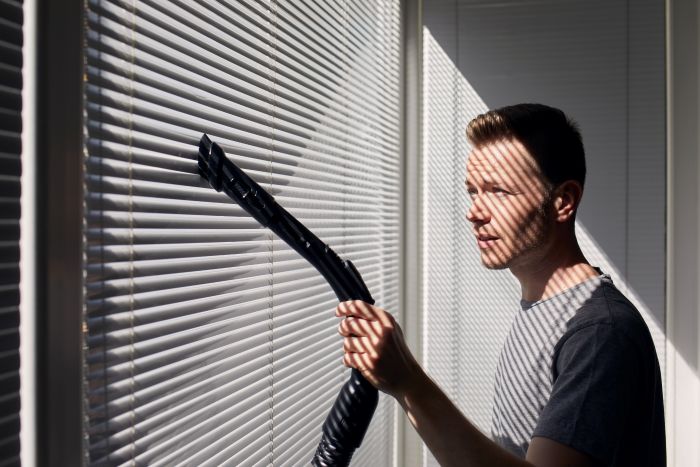 Man Cleaning Dust From Window Blind By Vacuum Cleaner Home Themes Housework Housekeeping