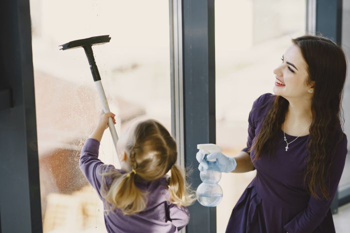 Daughter Mother Cleaning Window Together