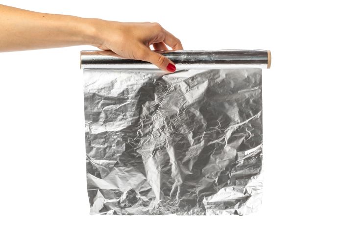 Human Hand Holding Roll Foil White Background