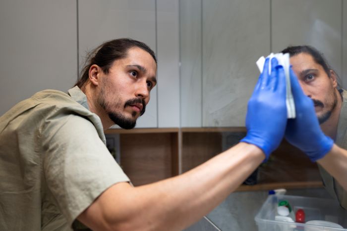 Side View Man Cleaning Mirror