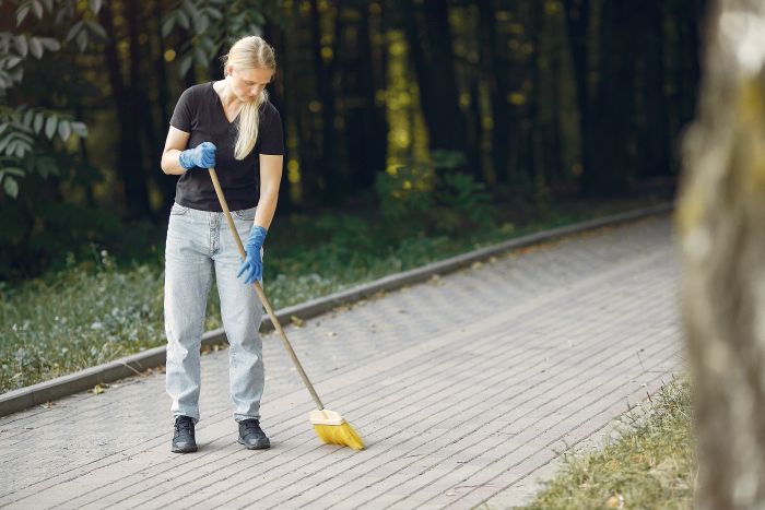 Woman Collects Leaves Cleans Park