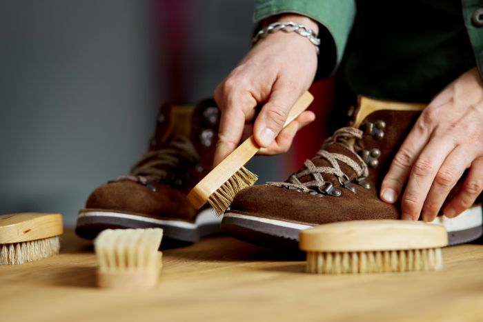 Man S Hand Cleaning Suede Shoes With Brush Wooden Floor