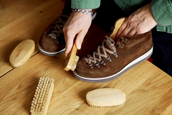 Man S Hand Cleans Suede Shoes With Brush