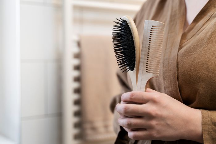 Young Adult Holding Brush Comb