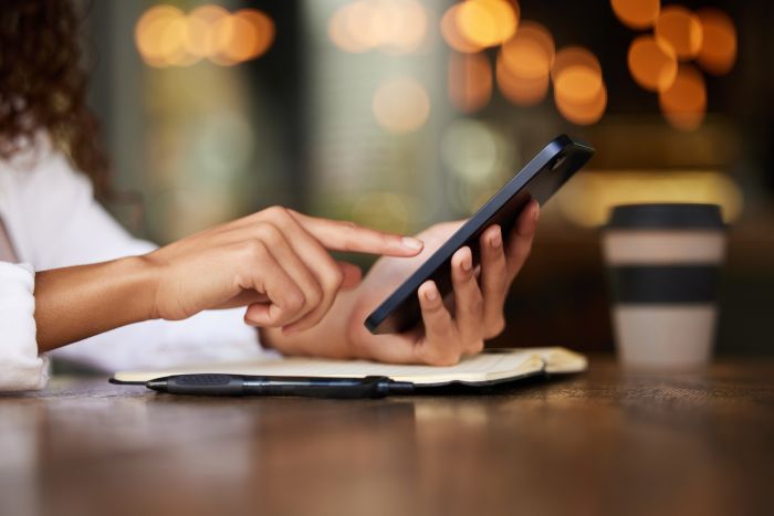 Cafe Person Hands With Smartphone With Internet Research News Update Information Journalist Notebook Online With Texting Browsing Website Mobile App Digital Application