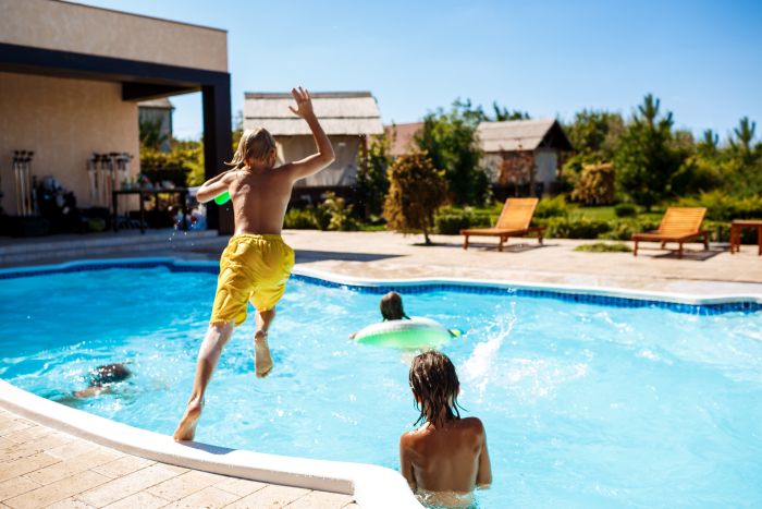 Cheerful Children Playing Waterguns Rejoicing Jumping Swimming Pool