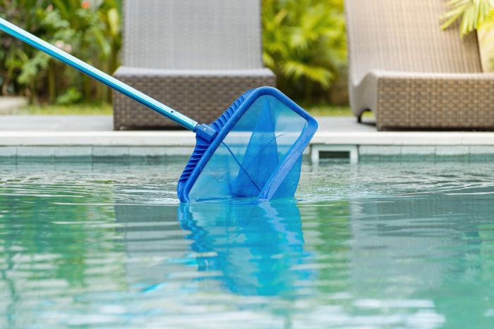 Cleaning Swimming Pool Fallen Leaves With Skimmer Net Equipment
