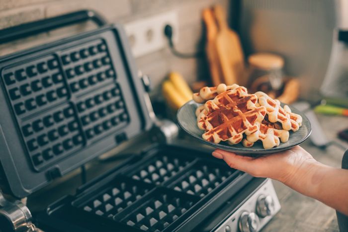 Cropped Hand Woman Holding Waffles Plate