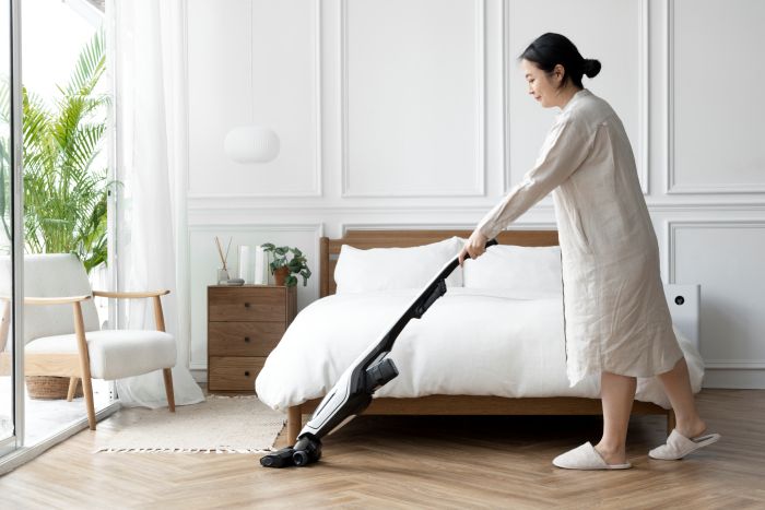 Japanese Woman Vacuuming Her Bedroom
