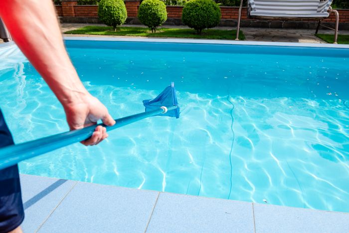Male Hand Holds Pool Net Cleaner