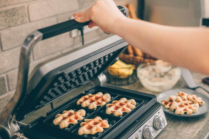 Midsection Woman Using Waffle Iron
