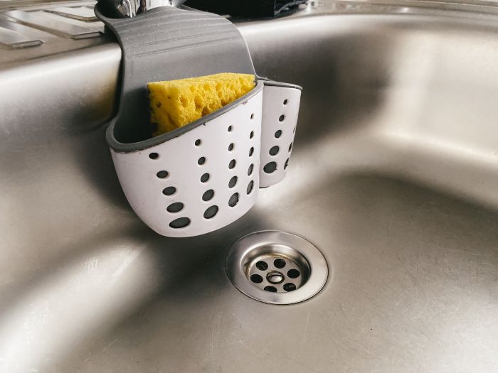 Sink With Sponge That Has Word Sponge It