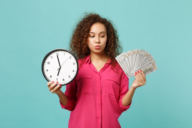 Pensive African Girl Pink Clothes Hold Round Clock Fan Money Dollar Banknotes Cash Money Isolated Blue Turquoise Background People Sincere Emotions Lifestyle Concept Mock Up Copy Space