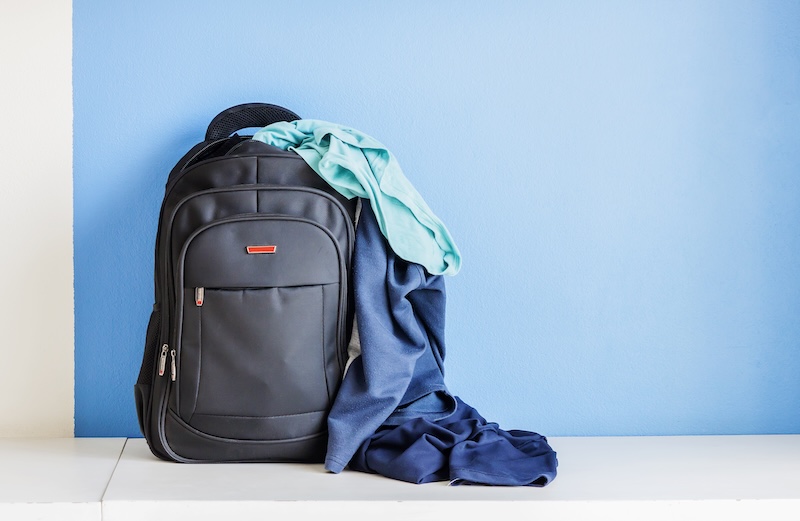 Rear View Man Against Blue Wall