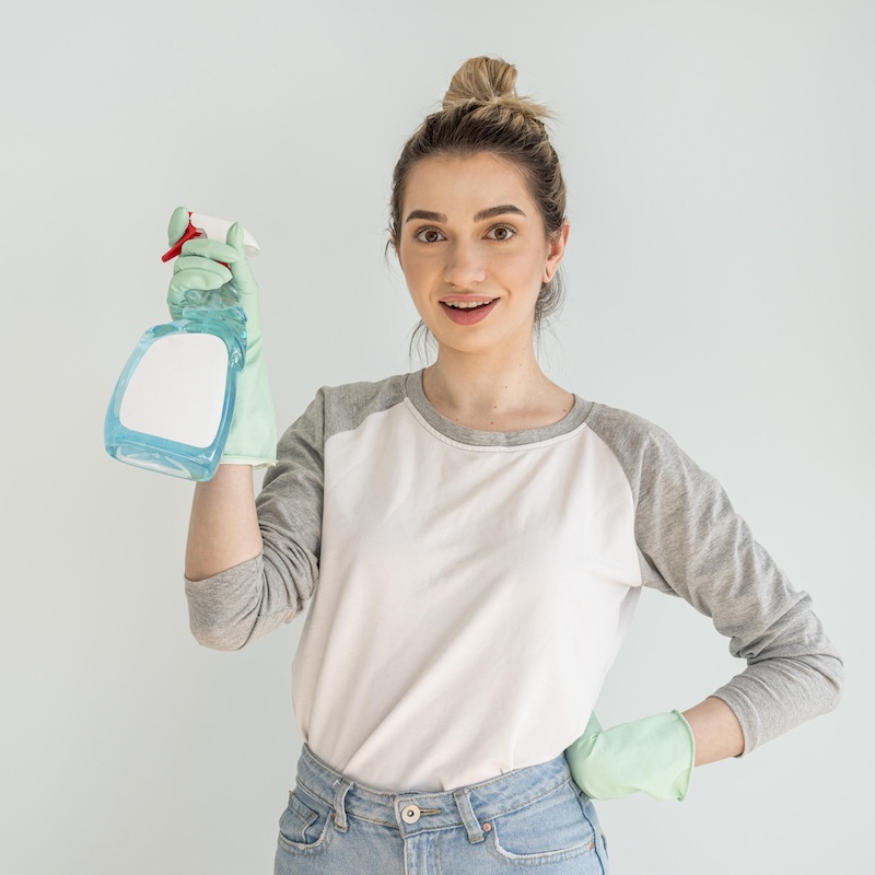 Woman Posing While Holding Cleaning Solution