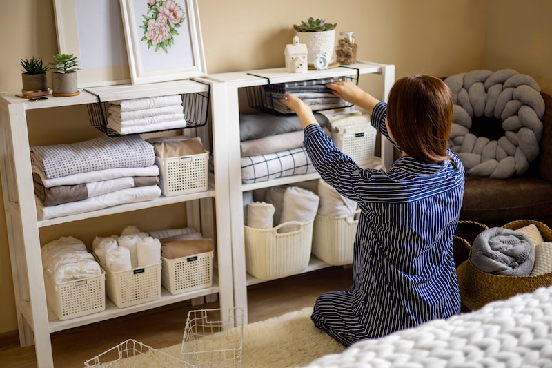 Domestic Woman Pajamas Neatly Putting Folded Linens Into Cupboard Vertical Storage Marie Kondo