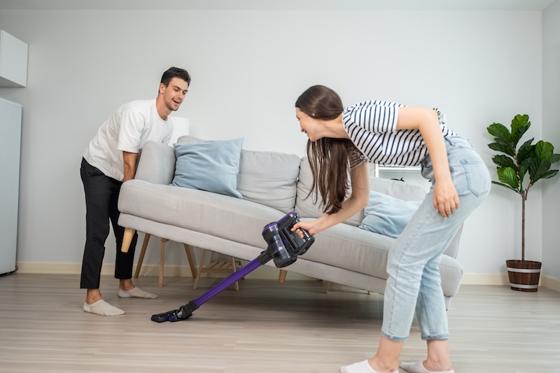 Caucasian Young Man Woman Cleaning Living Room Together Home Beautiful Lovely Couple Male Female Moving Sofa Vacuuming Messy Dirty Floor Housekeeping Housework Chores House