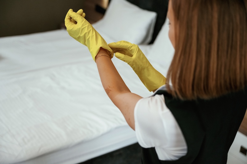 Wearing Yellow Gloves Young Chambermaid Is Hotel Room