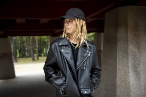 stylish person wearing a black cap, black t-shirt, and a black leather jacket