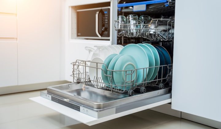 white kitchen opened dishwasher with clean dishes
